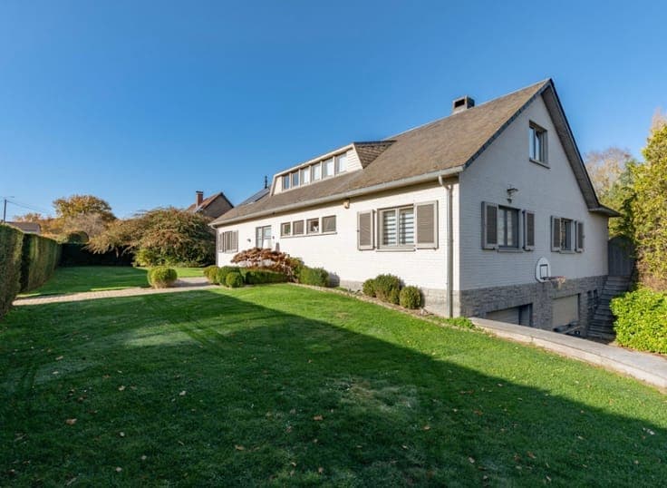 Stunning detached villa nestled in a lush green setting.