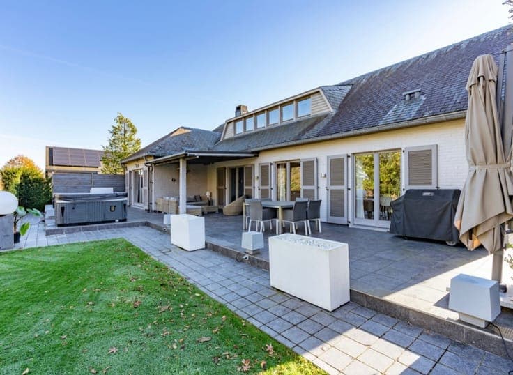 Stunning detached villa nestled in a lush green setting.
