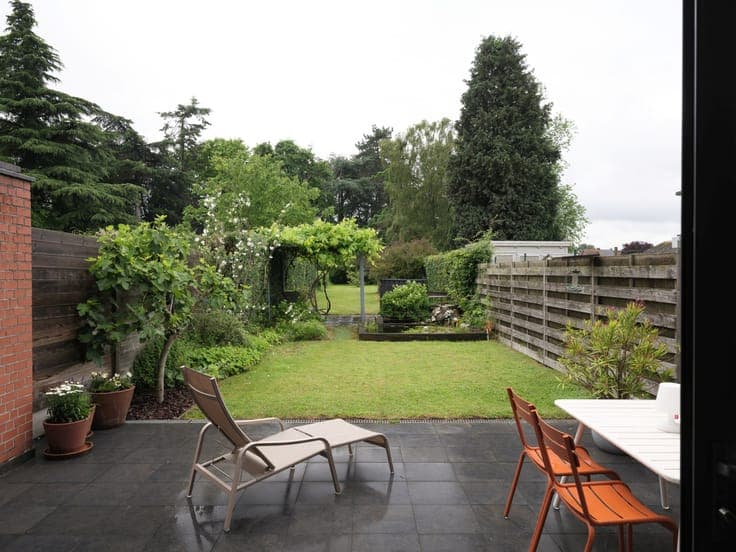 Turnkey home with abundant light and beautiful garden exper