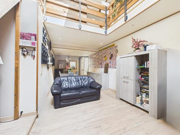 Mixed-use building with duplex, garages & storage in Ans