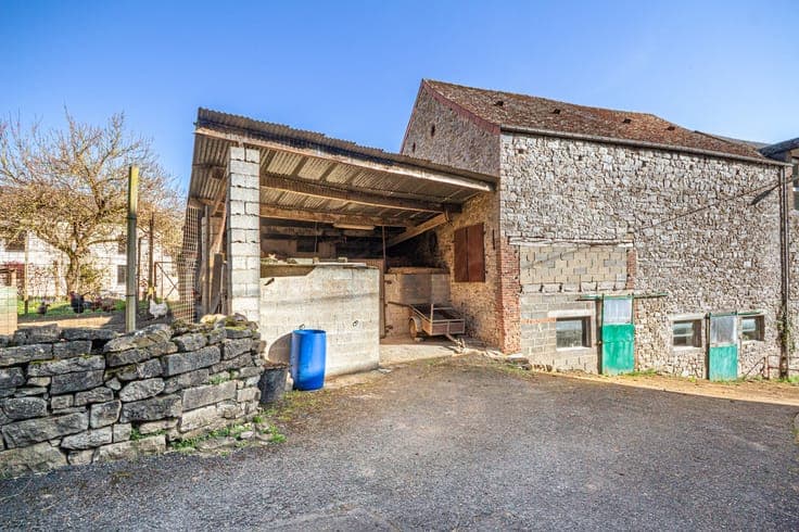 Old farmhouse in the heart of the village with outbuildings