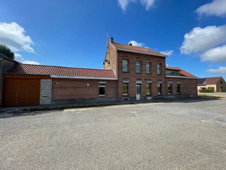 A spacious house with a garden and two large garages