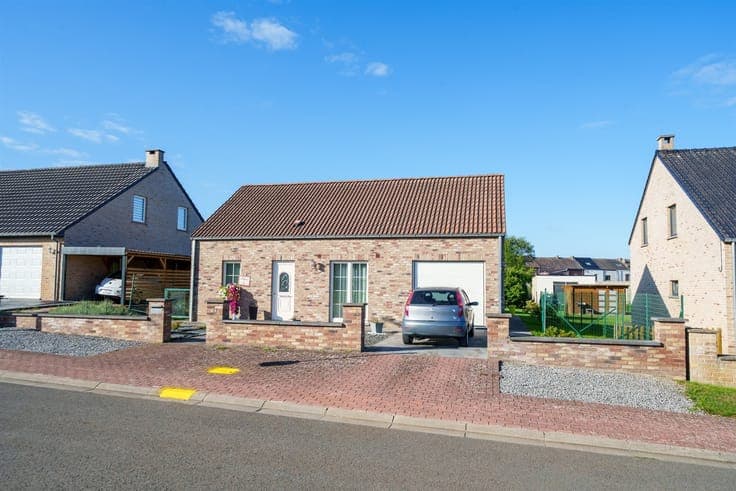 Single-story detached villa with a garden and garage
