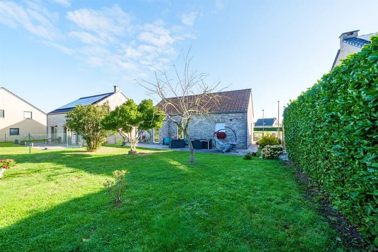 Single-story detached villa with a garden and garage