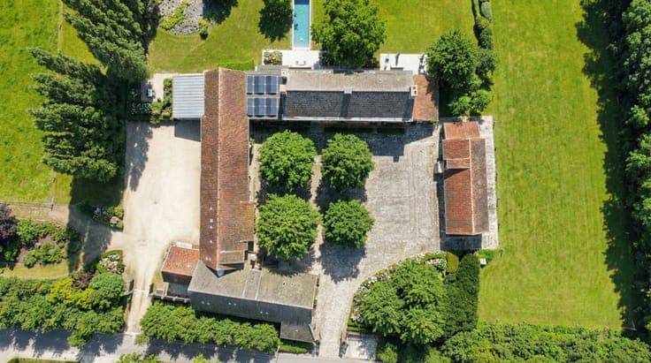 EXCEPTIONAL square farmhouse with numerous possibilities!