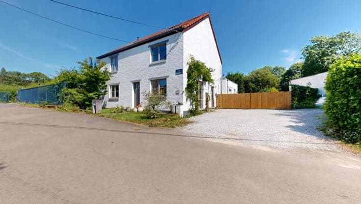 A charming, renovated house with a garage and an outbuilding