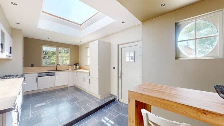 A charming, renovated house with a garage and an outbuilding