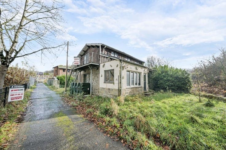 House in need of renovation on the banks of the Ourthe