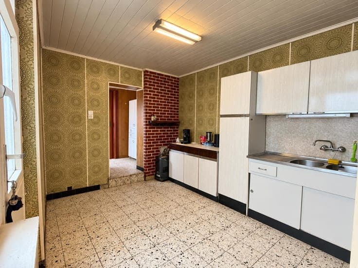 House in need of renovation with a garden and a side passage