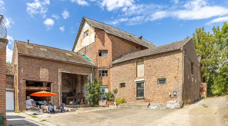 Property with two houses, a workshop, and a meadow