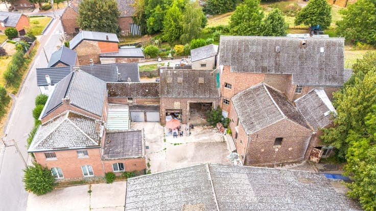 Property with two houses, a workshop, and a meadow