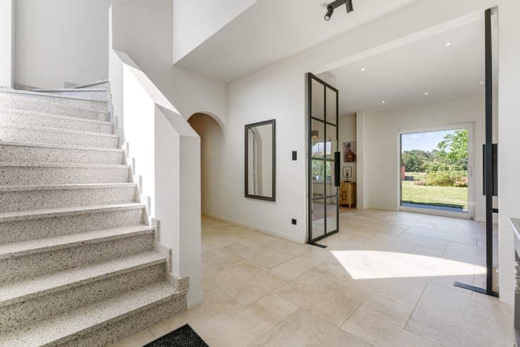 Classic villa with a view of meadows and a horse stable.