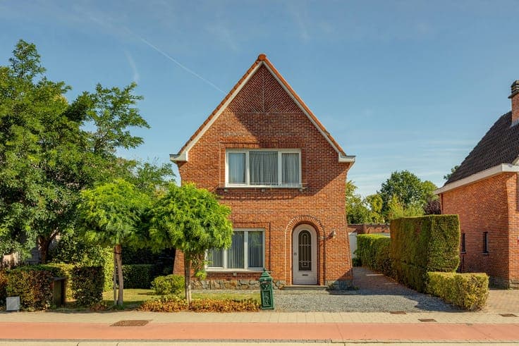 House with a garden, driveway, and garage